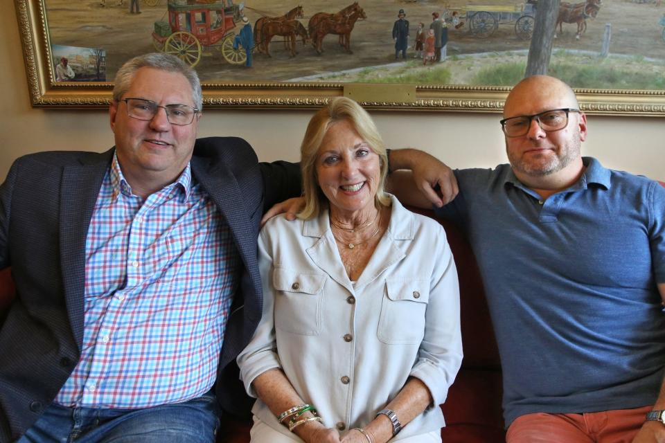 Florence Ruffner, started her real estate business in Exeter more than 40 years ago and now there are three generations of Ruffners on staff. She and her two sons, Lewis, left, and Scott gather on the couch for a photo.