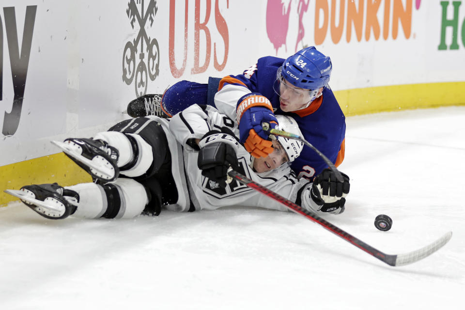 Los Angeles Kings center Blake Lizotte and New York Islanders defenseman Scott Mayfield (24) battle for the puck as they slide across the ice in the third period of an NHL hockey game Thursday, Jan. 27, 2022, in Elmont, N.Y. (AP Photo/Adam Hunger)