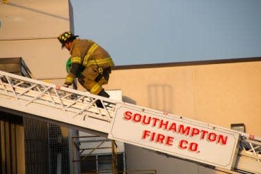 A Southampton Fire Co. volunteer shows how to climb a ladder as a demonstration for Fire Prevention Week.