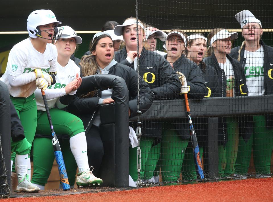 The Oregon bench cheers on their starters during the game against Arizona State.