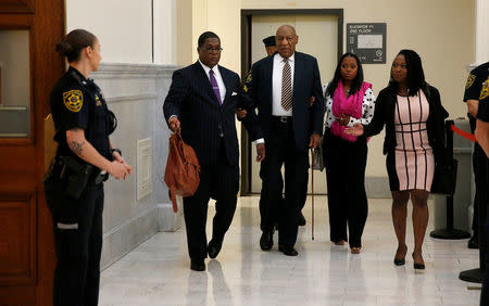 Actor and comedian Bill Cosby is helped through the metal detector as he arrives for the first day of his sexual assault trial at the Montgomery County Courthouse in Norristown, Pennsylvania, U.S. June 5, 2017. REUTERS/David Maialetti/Pool