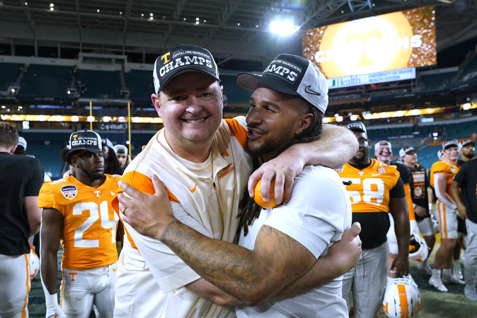 Tennessee coach Josh Heupel, left, hugs a member of the coaching staff after the team's win over Clemson in the Orange Bowl NCAA college football game, early Saturday, Dec. 31, 2022, in Miami Gardens, Fla. (AP Photo/Lynne Sladky)