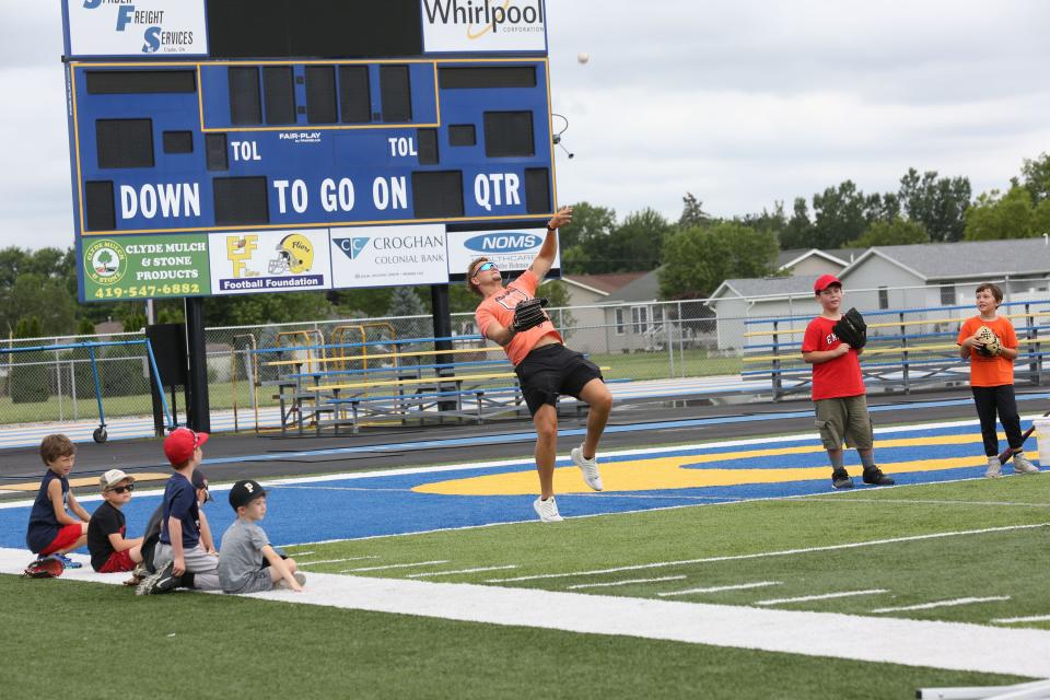 Clyde graduate and University of Findlay baseball player, Cam Farrar throws a pop-up, during a youth baseball camp held at Clyde High School, on Thursday and Friday.