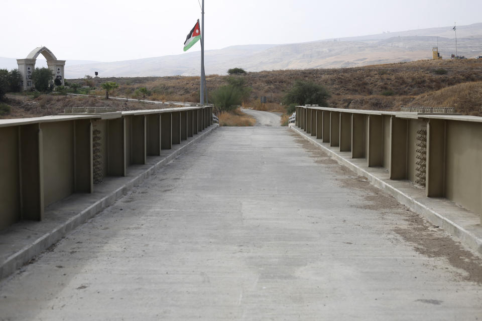A Jordanian flag flies on a bridge leading from Israel to Jordan in the Jordan valley area called Baqura, Jordanian territory that was leased to Israel under the 1994 peace agreement between the two countries, Monday, Oct. 22, 2018. Jordan's King Abdullah II on Sunday said he has decided not to renew the lease on two small areas of Baqura and Ghamr, that was part of his country's landmark peace treaty with Israel. The leases expire next year after 25 years. (AP Photo/Ariel Schalit)