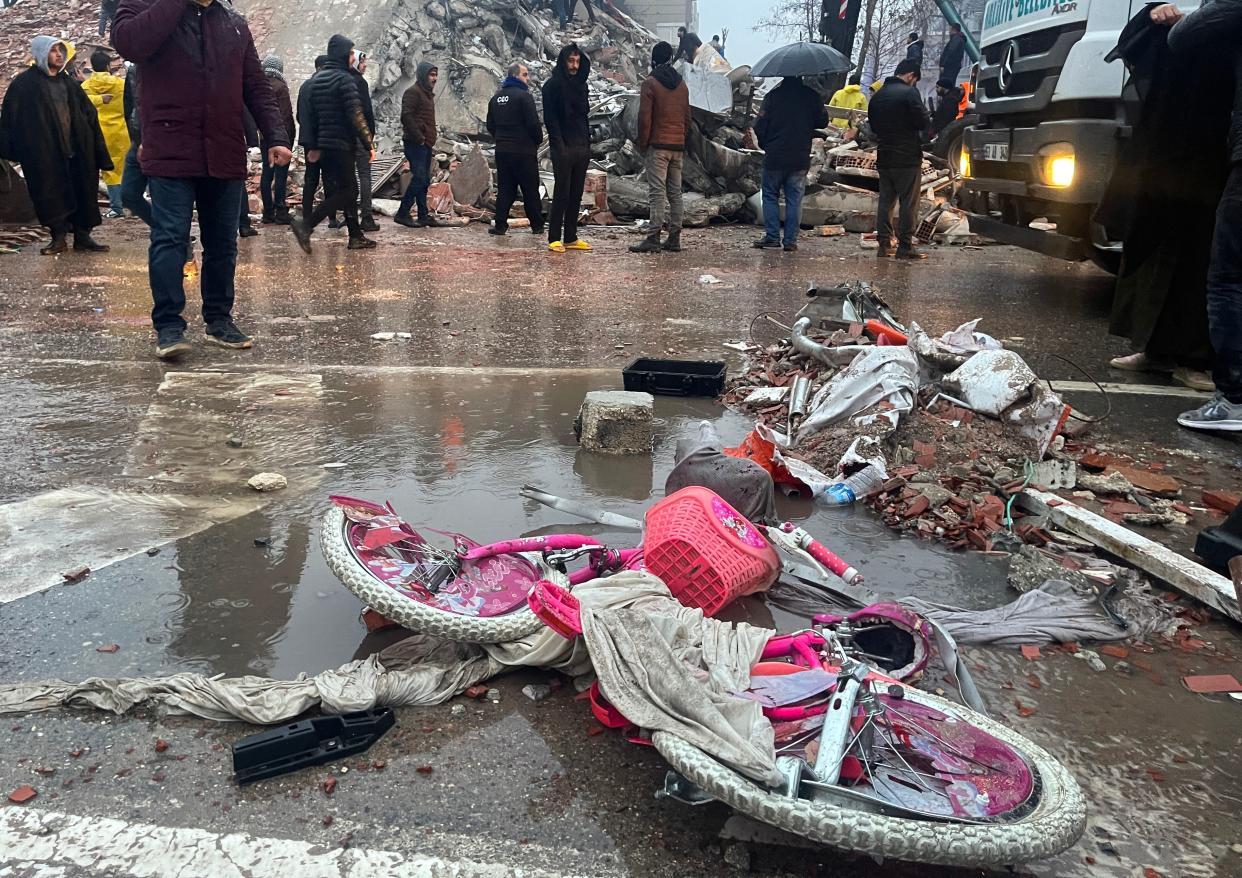 Rescuers search for survivors through the rubble in Sanliurfa, Turkey