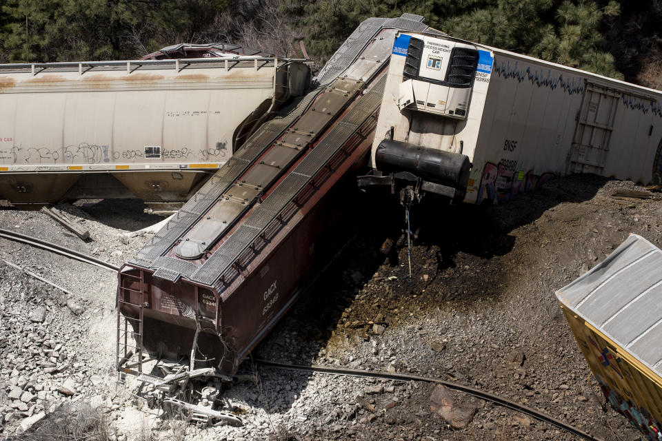 Derailed cars from a train lie near Quinn's Hot Springs Resort west of St. Regis, Mont., Sunday, April 2, 2023. Montana Rail Link is investigating the derailment in which there were no injuries reported. (Ben Allan Smith/The Missoulian via AP)