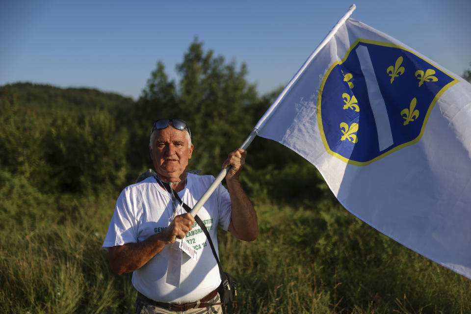 Osman Salkic, a Srebrenica survivor, poses for a photo before the start of the "March of Peace", march to remember the 1995 Srebrenica massacre in Nezuk, Bosnia, Saturday, July 8, 2023. A solemn peace march started on Saturday through forests in eastern Bosnia in memory of the 1995 Srebrenica massacre, Europe's only acknowledged genocide since World War II. The 100-kilometre (60-mile) march traces a route taken by Bosniak men and boys as they tried to flee Srebrenica after it was captured by Bosnian Serb forces in the closing days of the country's interethnic war in the 1990s. (AP Photo/Armin Durgut)