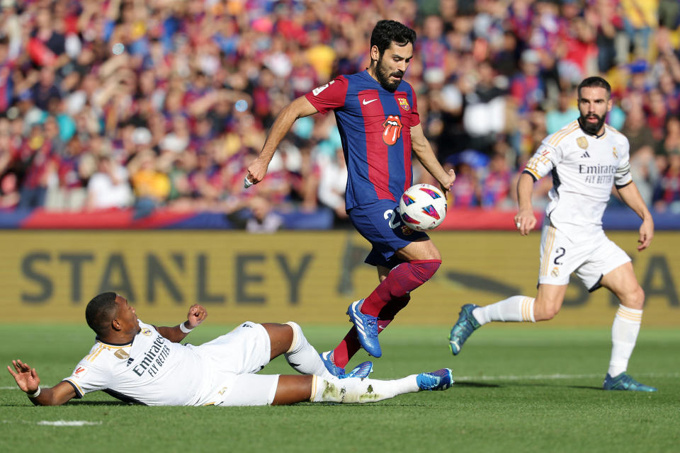 Barcelona's German midfielder #22 Ilkay Gundogan is tackled by Real Madrid's Austrian defender #04 David Alaba during the Spanish league football match between FC Barcelona and Real Madrid CF at the Estadi Olimpic Lluis Companys in Barcelona on October 28, 2023. (Photo by LLUIS GENE / AFP) (Photo by LLUIS GENE/AFP via Getty Images)