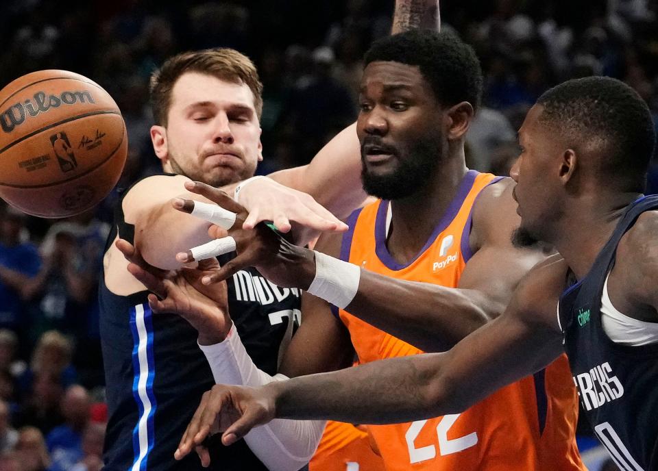 May 8, 2022; Dallas, Texas, USA;  Dallas Mavericks guard Luka Doncic (77) forces a turnover against Phoenix Suns center Deandre Ayton (22) during game four of the second round for the 2022 NBA playoffs at American Airlines Center.