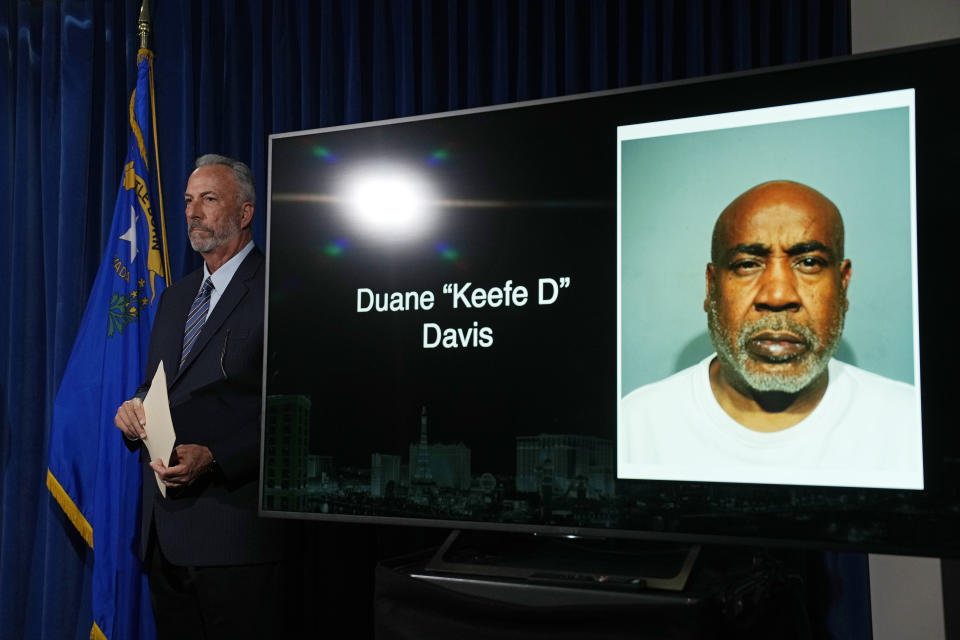 CAPTION CORRECTION: CORRECTS SPELLING OF NAME: Clark County District Attorney Steve Wolfson stands beside a photo of Duane "Keffe D" Davis during a news conference on an indictment in the 1996 murder of rapper Tupac Shakur, Friday, Sept. 29, 2023, in Las Vegas. Monitor in rear has name misspelled. (AP Photo/John Locher)