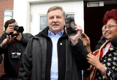 U.S. congressional candidate and State Rep. Rick Saccone emerges from his polling place while video chatting with his son at the Osan Air Base in South Korea. Saccone cast his vote in Pennsylvania's 18th U.S. Congressional district special election between Republican Saccone and Democratic candidate Conor Lamb at a polling place in McKeesport, Pennsylvania, U.S., March 13, 2018. REUTERS/Alan Freed