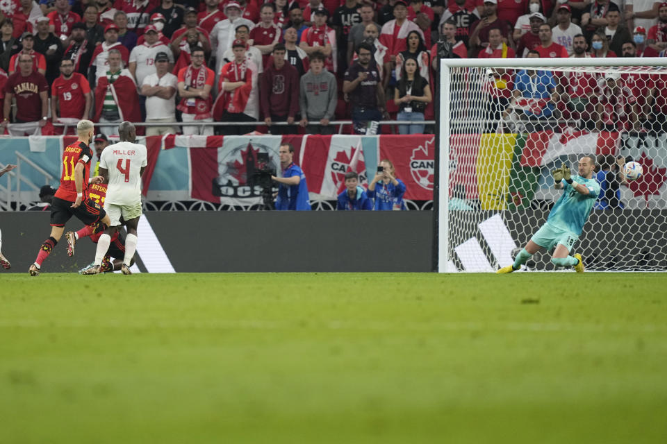 Belgium's Michy Batshuayi, second from left, scores his side's opening goal during the World Cup group F soccer match between Belgium and Canada, at the Ahmad Bin Ali Stadium in Doha, Qatar, Wednesday, Nov. 23, 2022. (AP Photo/Martin Meissner)