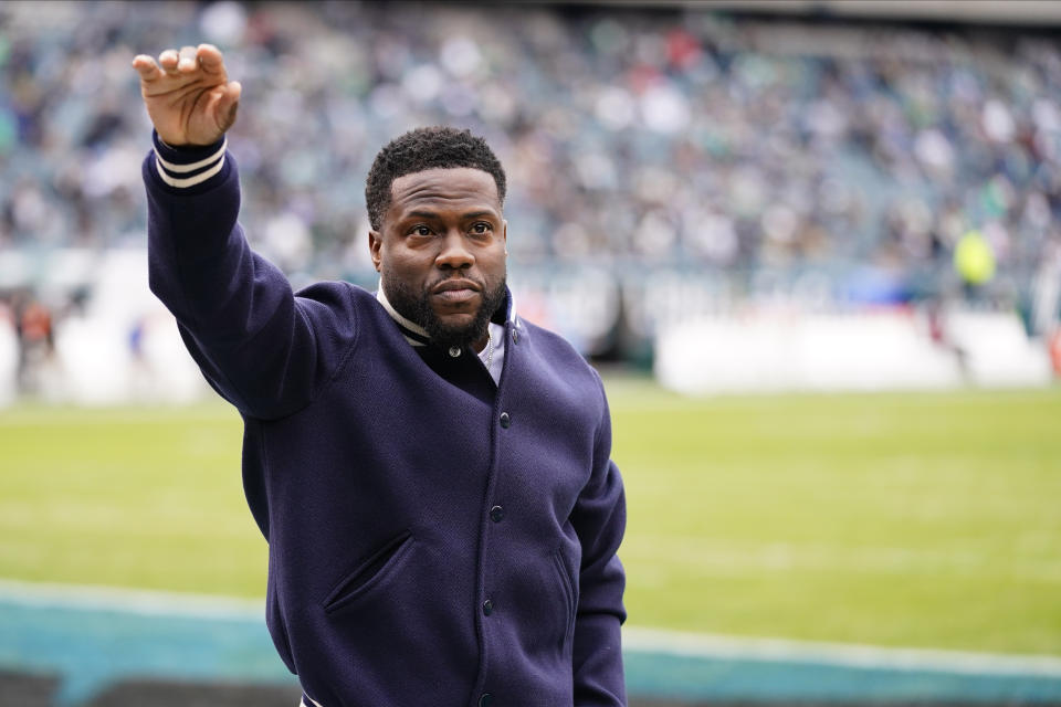 Entertainer Kevin Hart waves before an NFL football game between the Philadelphia Eagles and the New Orleans Saints, Sunday, Nov. 21, 2021, in Philadelphia. (AP Photo/Matt Rourke)