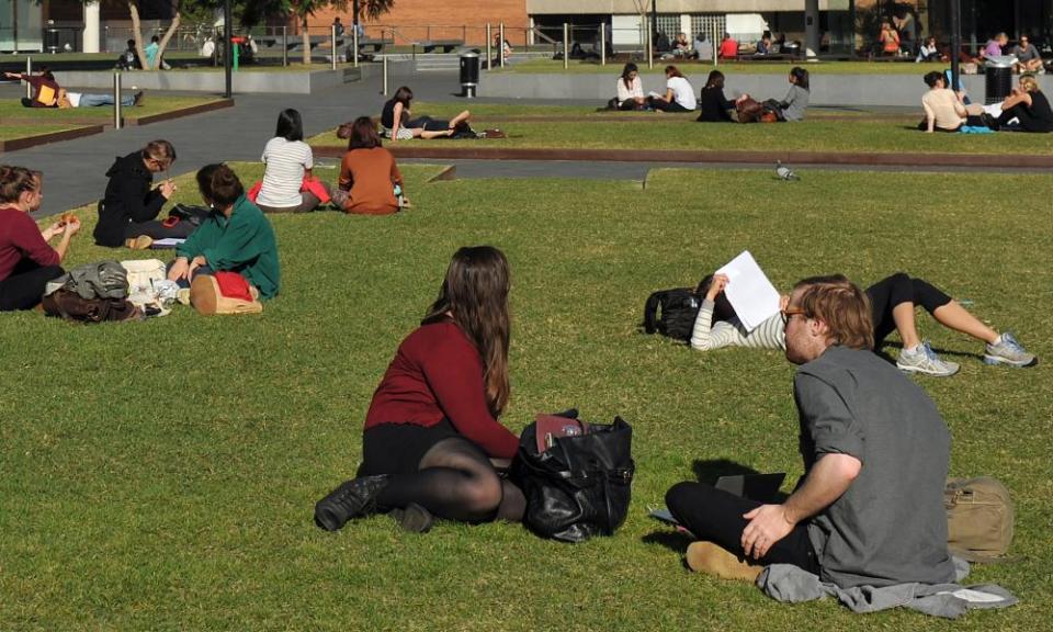 Students sit on the grass 