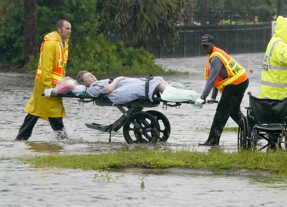 Authorities transport a person out of the Avante nursing home in Orlando amid floodwaters.