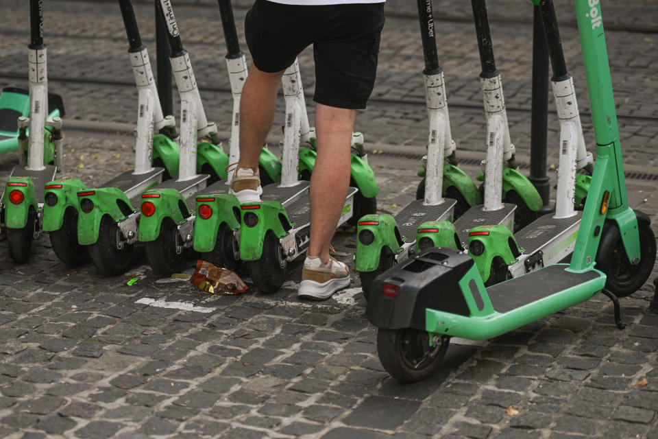 Row of green e-scooters. 