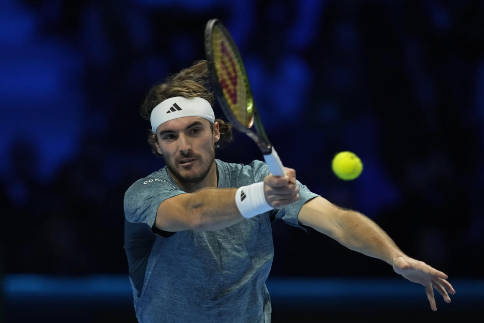 FILE - Greece's Stefanos Tsitsipas returns the ball to Italy's Jannik Sinner during their singles tennis match of the ATP World Tour Finals at the Pala Alpitour, in Turin, Italy, Sunday, Nov. 12, 2023. Tsitsipas is one of the players to watch at the Australian Open. The year's first Grand Slam tennis tournament is scheduled to start at Melbourne Park on Sunday. (AP Photo/Antonio Calanni, File)