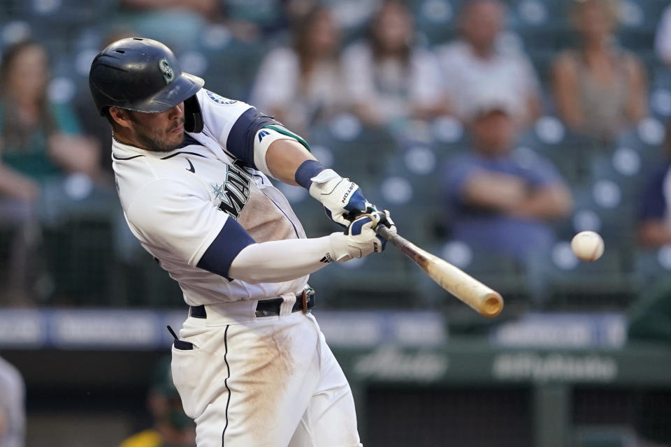 Seattle Mariners' Ty France hits a ground-rule RBI double during the third inning of the team's baseball game against the Oakland Athletics, Tuesday, June 1, 2021, in Seattle. (AP Photo/Ted S. Warren)
