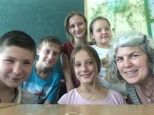 Former Evansville resident Kathy Bailey (front right) poses with her Ukrainian students.