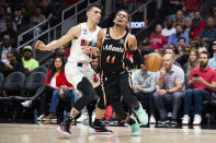 Atlanta Hawks guard Trae Young is fouled by Miami Heat guard Tyler Herro during the first half of an NBA basketball game, Sunday, Nov. 27, 2022, in Atlanta. (AP Photo/Hakim Wright Sr.)