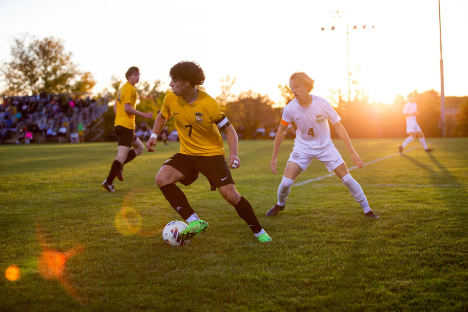 East's Isaac Fernandez keeps the ball away from the Reeths-Puffer defense Tuesday, Oct. 4, 2022, at Zeeland East High School.