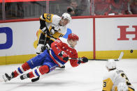 Washington Capitals center Lars Eller (20), of Denmark, falls to the ice next to Pittsburgh Penguins center Sidney Crosby (87) during the third period of an NHL hockey game, Sunday, Feb. 2, 2020, in Washington. (AP Photo/Nick Wass)