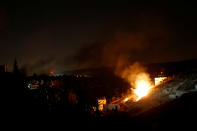 <p>Flames are seen during a raid by Israeli forces on a house in which Palestinian Hamas fighter Mohammad al-Fakih was hiding out in the West Bank village of Surif, near Hebron July 27, 2016. (Photo: Mussa Qawasma/Reuters)</p>