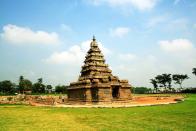 Shore Temple at Mahabalipuram or Mamallapuram. The Shore Temple (built in 700-728 AD) stands against the background of the Bay of Bengal. It belongs to a period when the constructional style of the Pallavas was at its peak in decorative beauty and intrinsic quality. Its pyramidal structure is 60 feet high and sits on a 50-feet square platform. There is a small temple in front, which was the original porch. It is made of finely cut local granite. One of the group of monuments at Mahabalipuram, it has been classified as a UNESCO World Heritage Site and is one of the oldest structural (versus rock-cut) stone temples of South India.