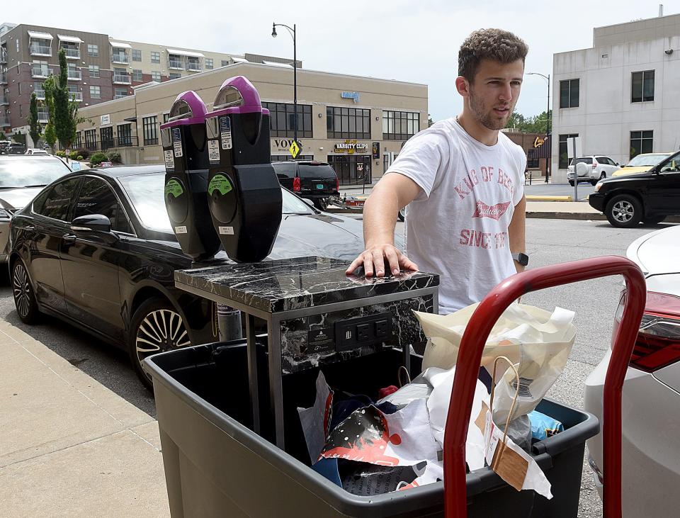 A.J. Spinello moves items from his old apartment to his new apartment at District Flats at 127 S. Eighth St. on Monday. Spinello is studying to obtain a master’s degree in business at the University of Missouri. He already owns a business called K.C. Vending Co.