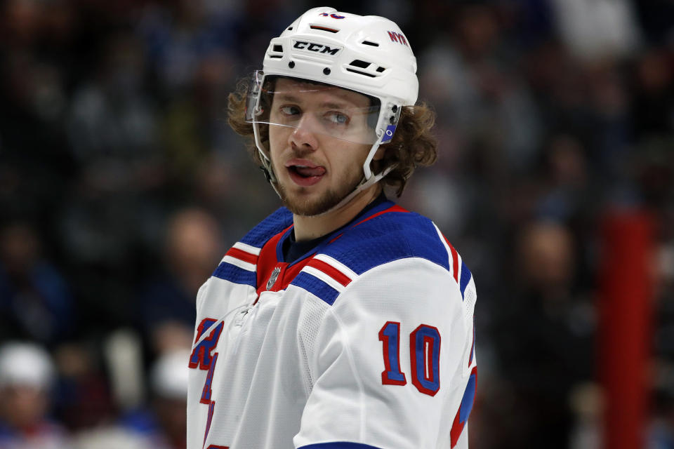 FILE - New York Rangers left wing Artemi Panarin (10) is shown in the second period of an NHL hockey game in Denver, in this Wednesday, March 11, 2020, file photo. New York Rangers star Artemi Panarin is taking a leave of absence after a Russian tabloid printed allegations from a former coach that he attacked an 18-year-old woman in Latvia in 2011. Ex-NHL enforcer Andrei Nazarov is the source for the report after coaching Panarin in the Kontinental Hockey League. Nazarov says he was motivated to speak about it because he disagreed with Panarin’s repeated criticism of the Russian government. Panarin denied the allegations in a statement released by the Rangers. (AP Photo/David Zalubowski, File)