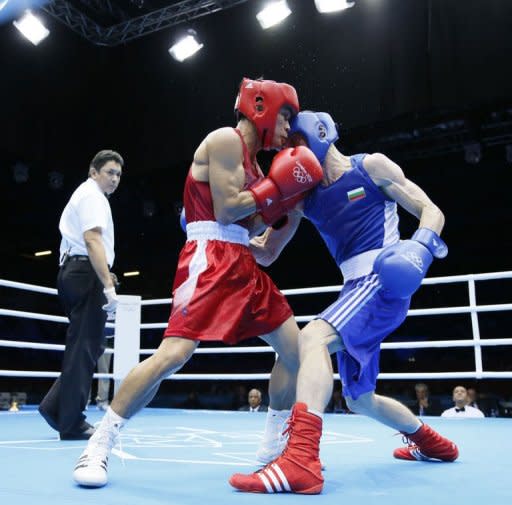 Kaeo Pongprayoon of Thailand (in red) defends against Aleksandar Aleksandrov of Bulgaria (in blue) during the Light Flyweight boxing quarterfinals of the 2012 London Olympic Games at the ExCel Arena in London. Pongprayoon advanced to the semi-finals with a 16-10 points decision