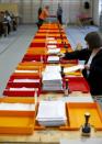 A member of an election office stamps ballots in Zurich, Switzerland, October 18, 2015. REUTERS/Arnd Wiegmann