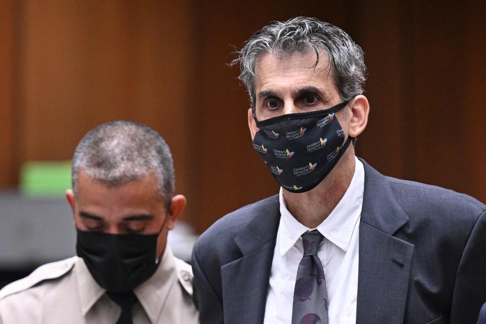 Hollywood television producer Eric Weinberg, right, looks up after bail was denied at his arraignment on Oct. 25, 2022, in Superior Court in Los Angeles. Weinberg, executive producer for the hit TV show "Scrubs," was denied bail after pleading not guilty to sexually assaulting five women who prosecutors said he lured to photo shoots.