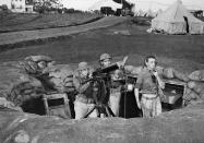 <p>Troops man a machine gun nest at Wheeler Field, which adjoins Schofield Barracks in Honolulu, after the Japanese attack on the island of Oahu, Dec. 7, 1941. (AP Photo) </p>