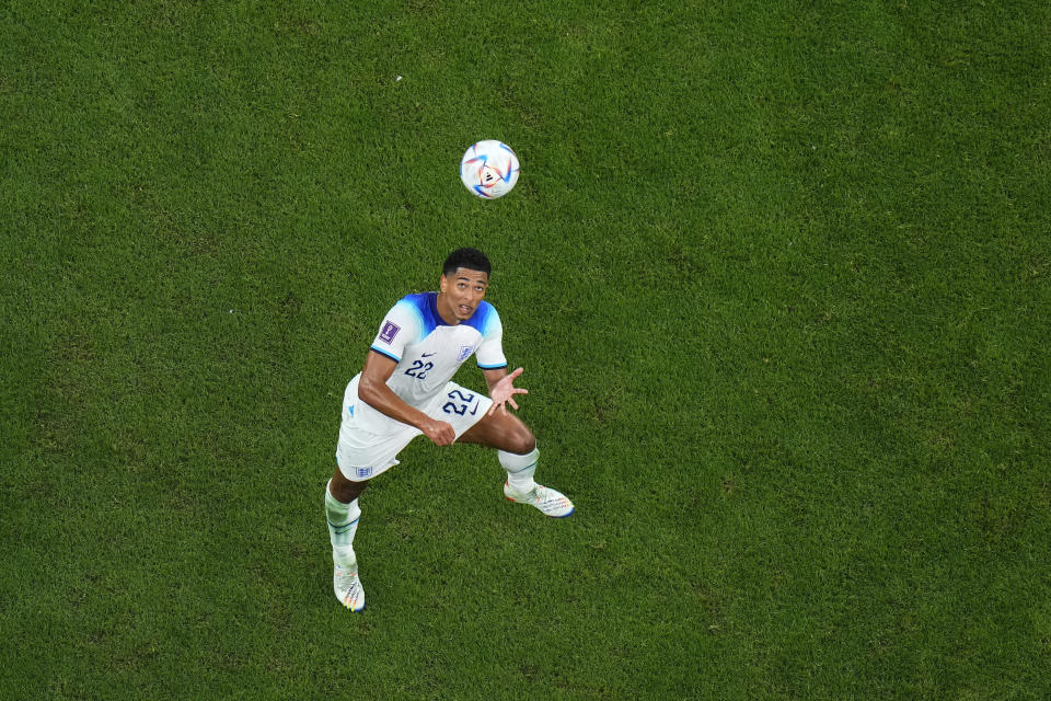 England's Jude Bellingham look up the ball during the World Cup round of 16 soccer match between England and Senegal, at the Al Bayt Stadium in Al Khor, Qatar, on Sunday, Dec. 4, 2022. (AP Photo/Petr David Josek)