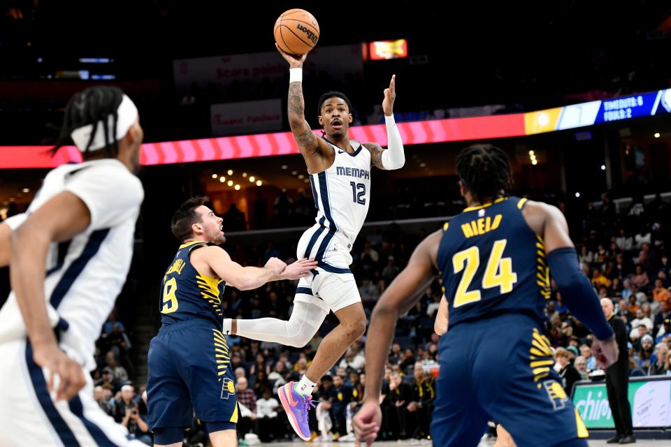 Grizzlies guard Ja Morant (12) passes the ball over Indiana Pacers guard T.J. McConnell (9)  during a Jan. 29 game in Memphis.