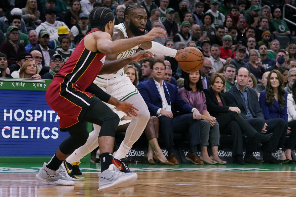 Britain's Prince William and Kate, Princess of Wales, at right, watch as Boston Celtics guard Jaylen Brown drives to the basket against Miami Heat guard Gabe Vincent (2) during the first half of an NBA basketball game, Wednesday, Nov. 30, 2022, in Boston. (AP Photo/Charles Krupa)