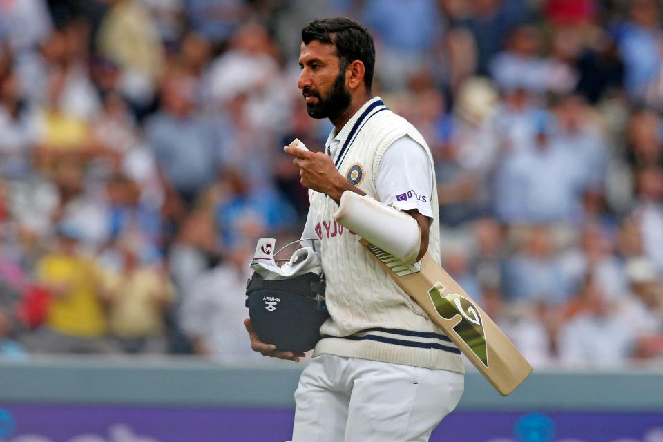 India's Cheteshwar Pujara walks back to the pavilion after losing his wicket for 45 runs on the fourth day of the second cricket Test match  between England and India at Lord's cricket ground in London on August 15, 2021. (Photo by IAN KINGTON/AFP via Getty Images)