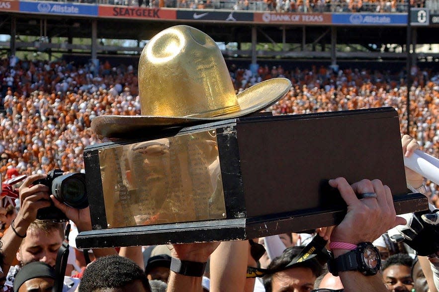 The Golden Hat Trophy is raised after the Red River Rivalry college football game between the University of Oklahoma Sooners and the University of Texas Longhorns at the Cotton Bowl