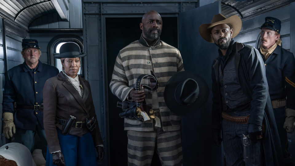 Regina King and LaKeith Stanfield dress in Old West garb as they break Idris Elba in old-fashioned prison stripes out of jail on a train.