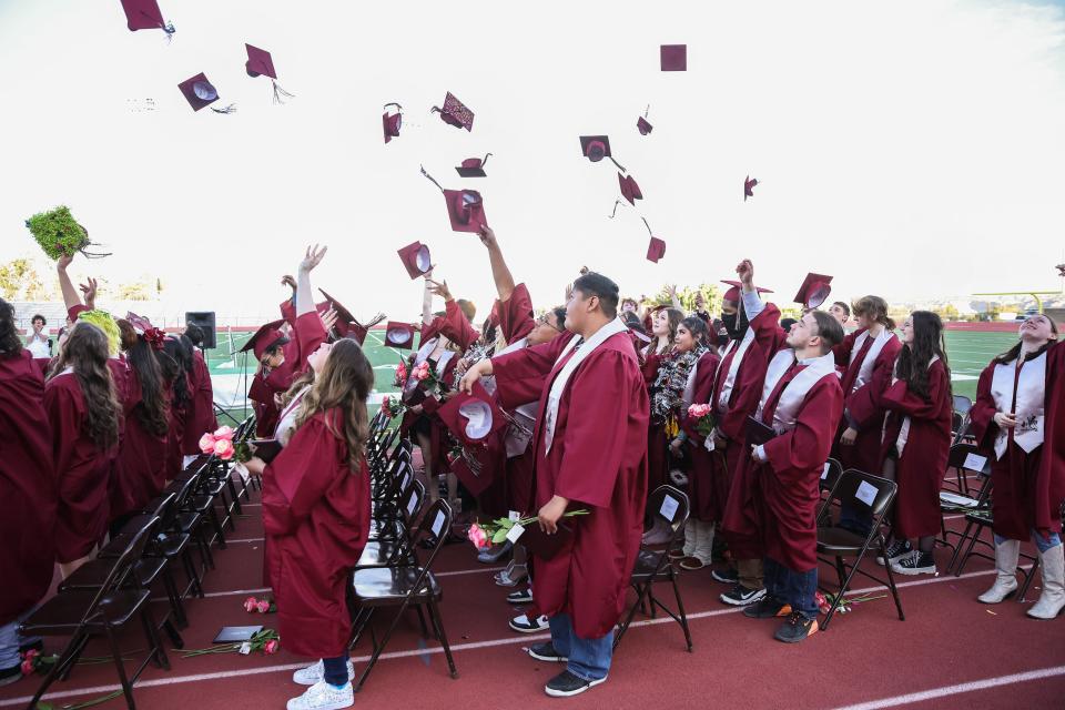 Rocinante High School Class of 2022 throw their caps in the air in celebration at the conclusion of the graduation ceremony on Wednesday, May 18, at Hutchison Stadium.