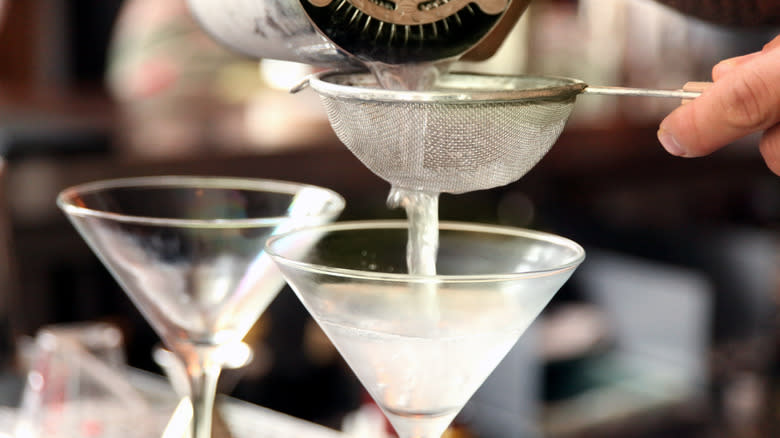 Bartender crafting martinis