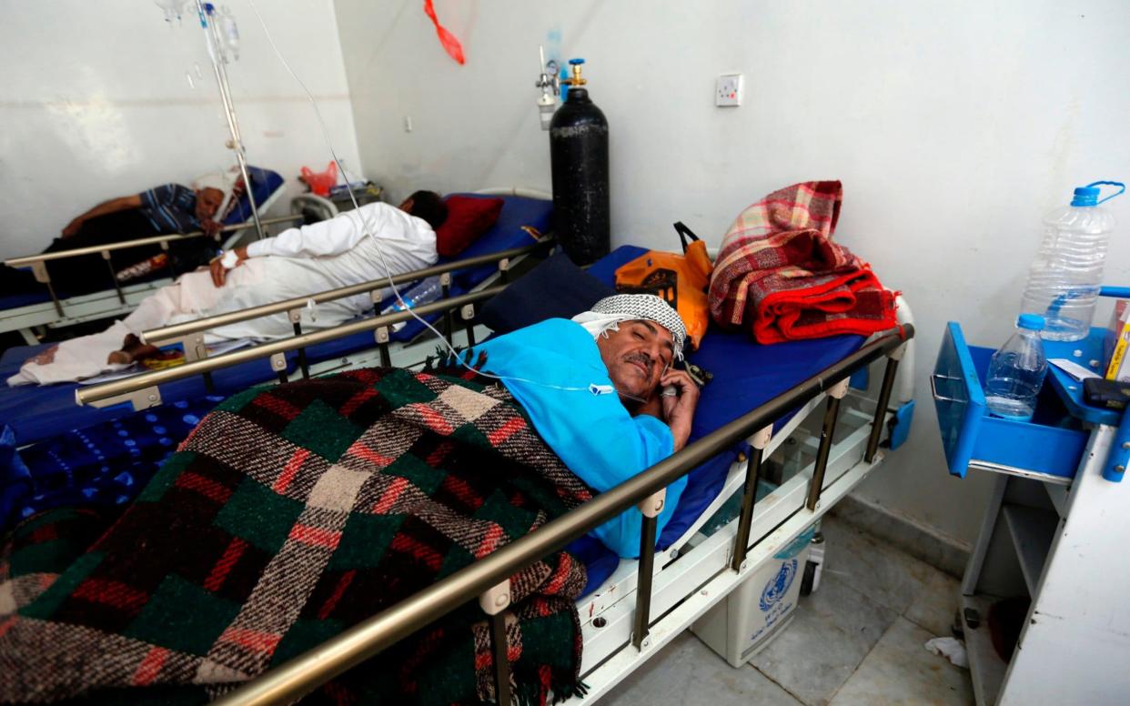 A Yemeni men suspected of being infected with cholera receives treatment at a hospital in Sanaa - AFP