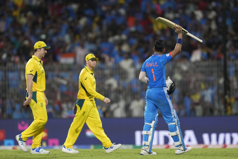 India's KL Rahul, right, raises his bat as he acknowledges the crowd after winning the ICC Cricket World Cup match against Australia in Chennai, India, Sunday, Oct. 8, 2023. (AP Photo/Rafiq Maqbool)