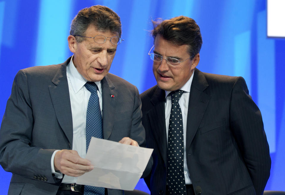 Chairman of the holding company Air France-KLM Group Jean-Cyril Spinetta, left, with Air France chairman and chief executive, Alexandre de Juniac, right, attend the company's Shareholders' meeting in Paris, Thursday, May 31, 2012. France's finance minister personally asked the former head of Air France-KLM to return a euro400,000 ($497,520) payout on Thursday, as the country's new Socialist government tries to rein in executive pay. Pierre Moscovici said on France Inter radio that the money, paid as compensation for a non-compete clause in the executive's contract, "doesn't go in the direction of decency." The French government, which holds a 15.9 percent stake in the Franco-Dutch carrier, will vote against the payment at a shareholder's meeting Thursday, and Air France-KLM CEO Jean-Cyril Spinetta said that the measure seemed likely to be rejected.(AP Photo/Jacques Brinon)