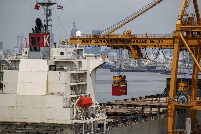 FILE PHOTO: A container is loaded onto a cargo ship at a port in Bangkok