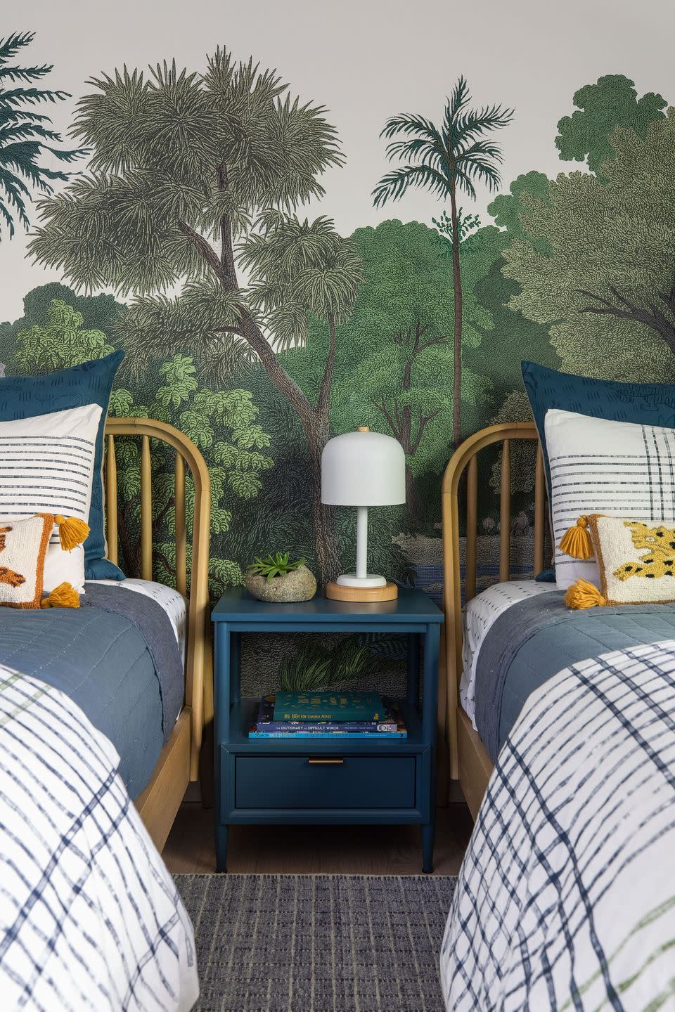 kids bedroom with two beds and jungle mural