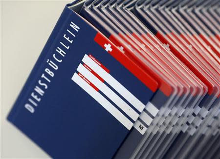 Swiss army service books are seen at a recruiting centre in Sumiswald, outside Bern August 27, 2013. REUTERS/Ruben Sprich