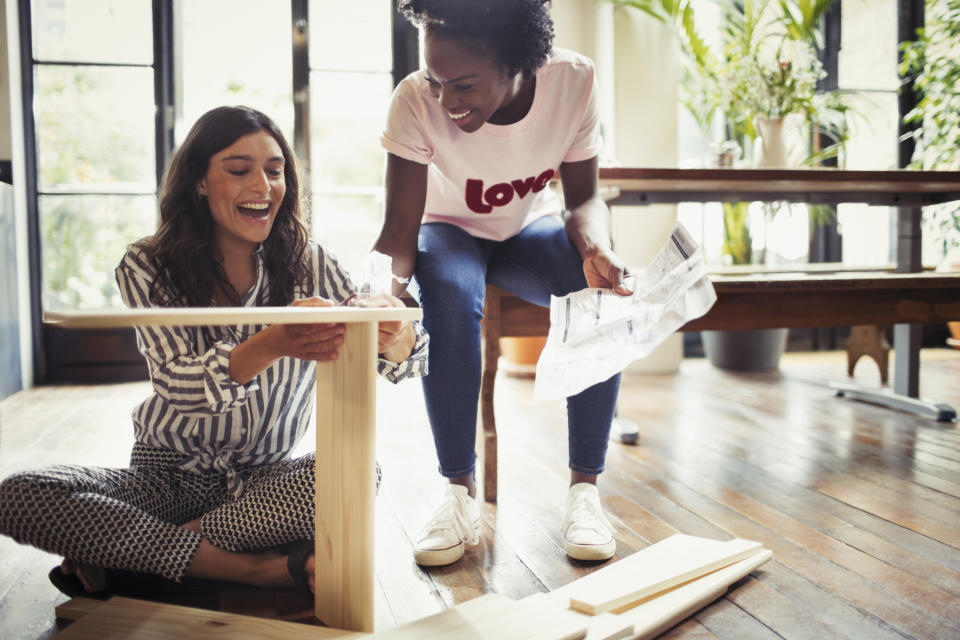 Couple assembles flatpack furniture. Image: Getty