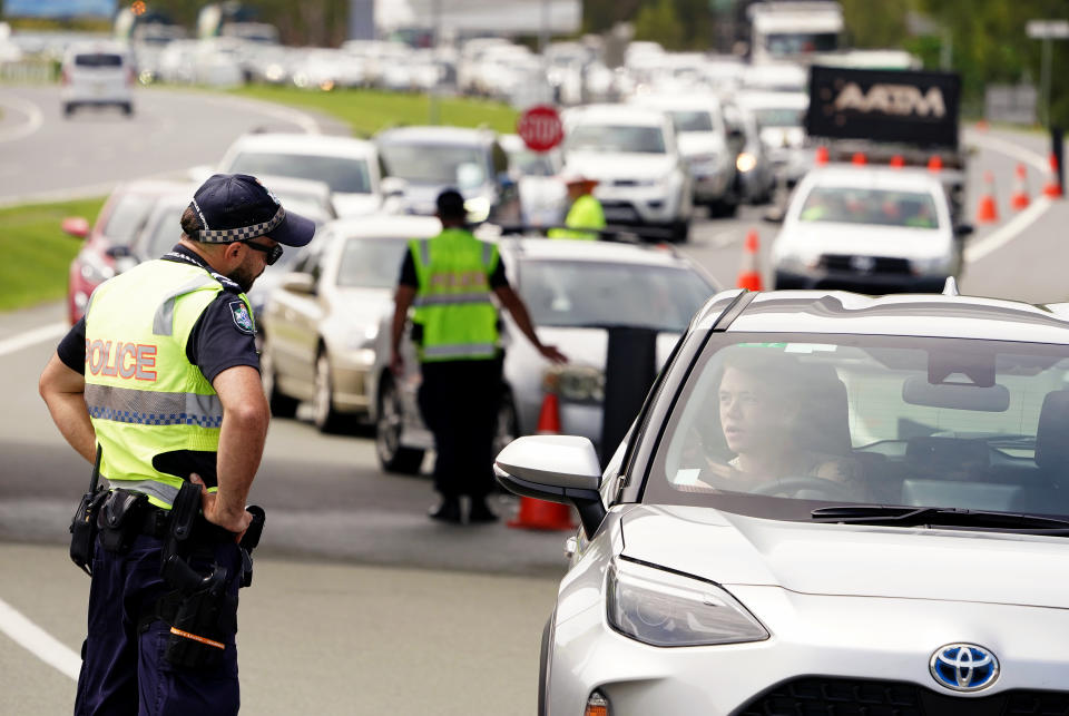 Queensland police question a motorist at the Queensland / New South Wales border checkpoint. Source: AAP